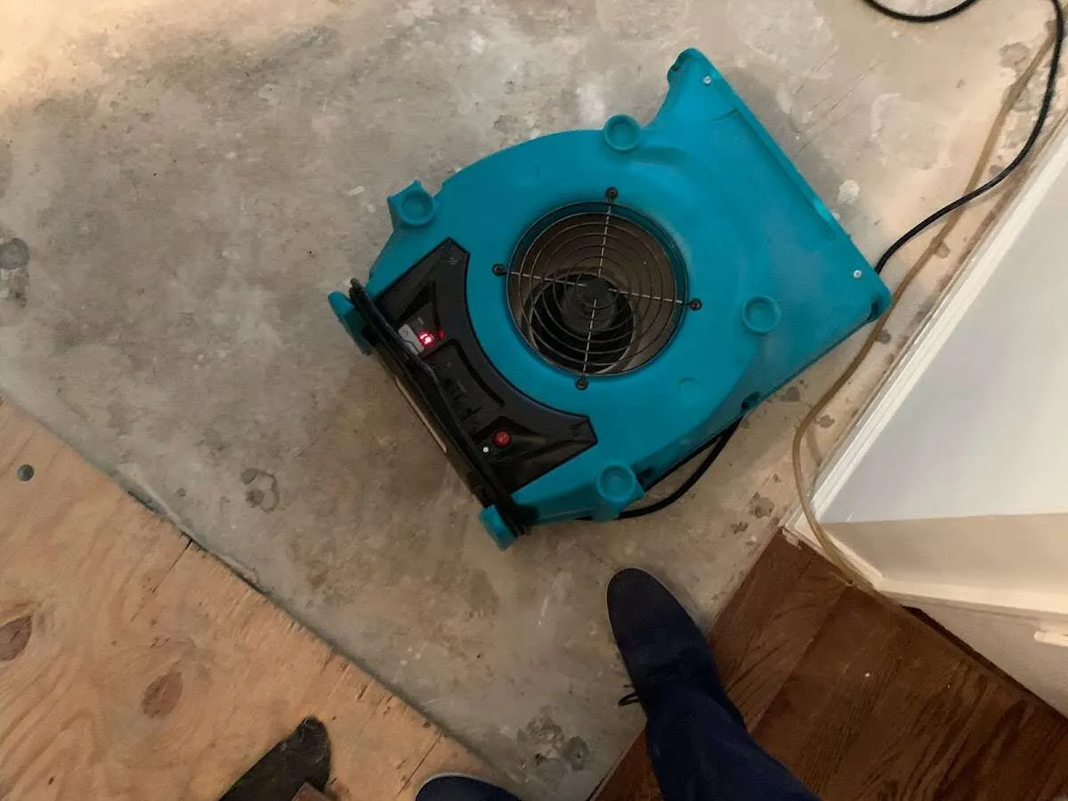 Air mover drying subfloor during Commercial Water Damage Restoration in Worthington